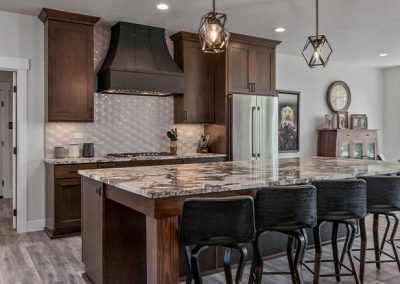 A custom kitchen with a center island and bar stools.