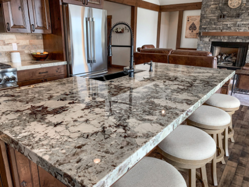 a kitchen island with granite countertops