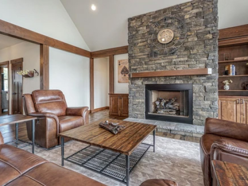 traditionally furnished rustic living room with a large fireplace