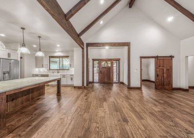 A large open kitchen with wood floors and vaulted ceilings.