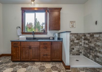 A bathroom with wood cabinets and a window.