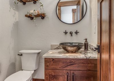 A bathroom with wood floors and a toilet.