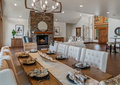 A large dining room with a stone fireplace.