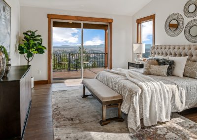 A bedroom with a large bed and a view of the mountains.
