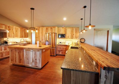 A kitchen with wooden cabinets and counter tops.