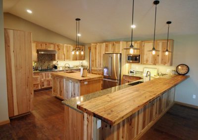 A kitchen with wooden cabinets and counter tops.