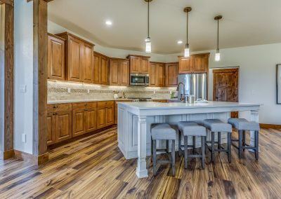 A kitchen with wood floors and a center island.