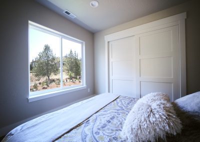 A bed in a bedroom with a view of the mountains.