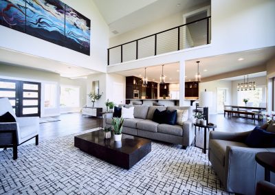 A living room with a large painting on the wall.