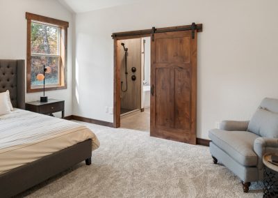 A bedroom with a sliding barn door.