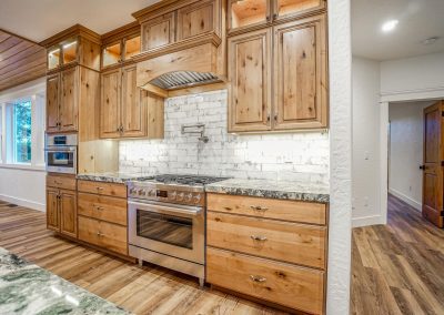 A kitchen with wood cabinets and granite counter tops.