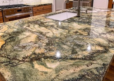 A kitchen with a green granite counter top.
