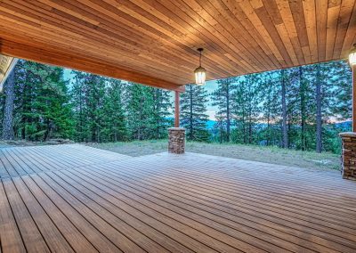 A wooden deck with a view of the mountains.