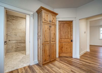 A room with wood floors and a wooden door.
