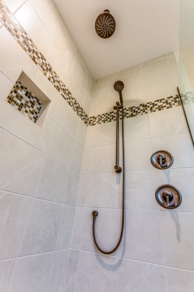 A bathroom with a shower head and shower head.