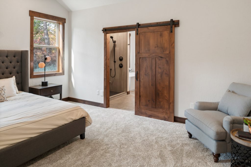 A bedroom with a sliding barn door.