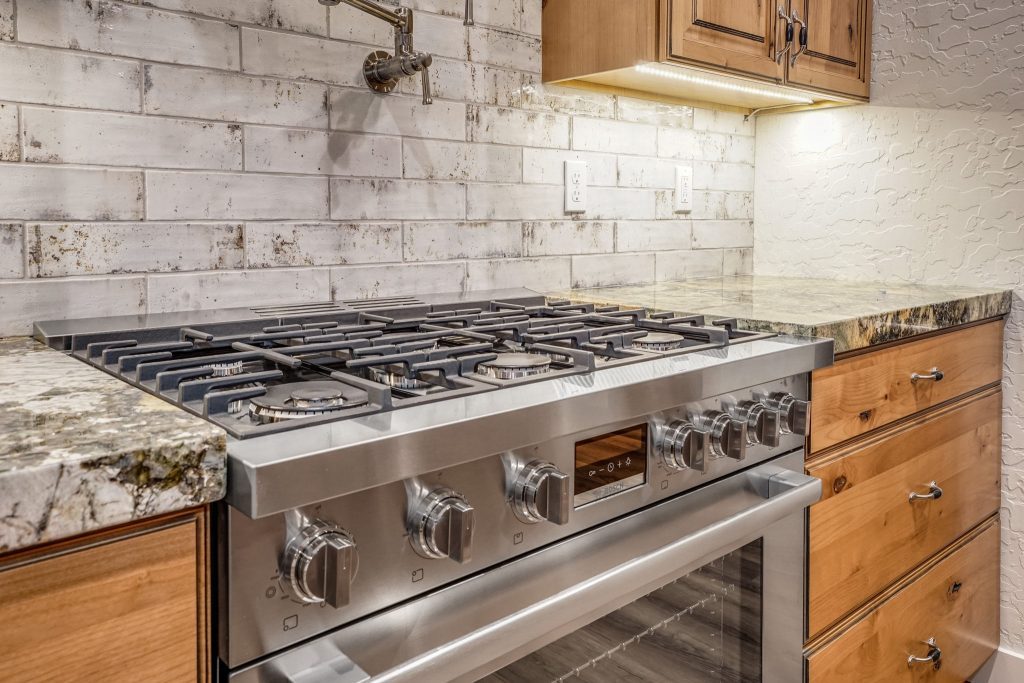 A kitchen with stainless steel appliances and granite counter tops.