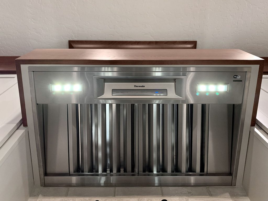 A stainless steel hood in a kitchen.