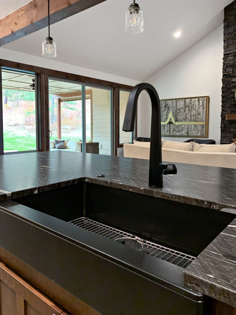 A kitchen with a black kitchen sink.