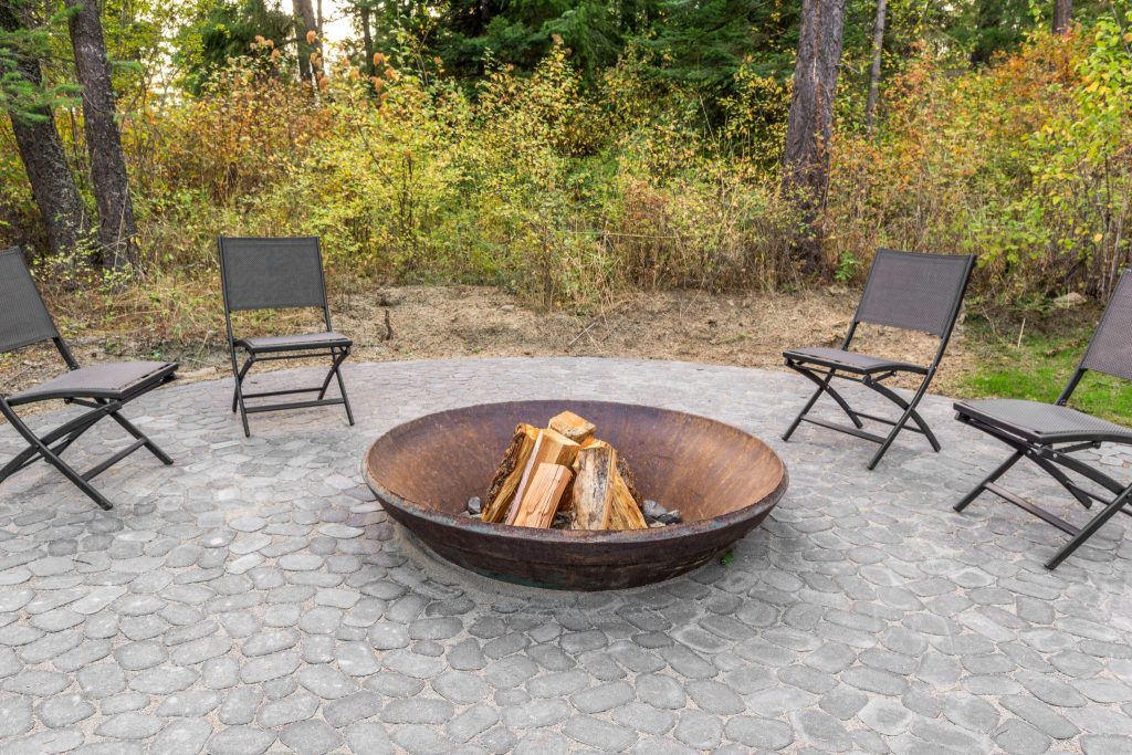 A fire pit in a wooded area.