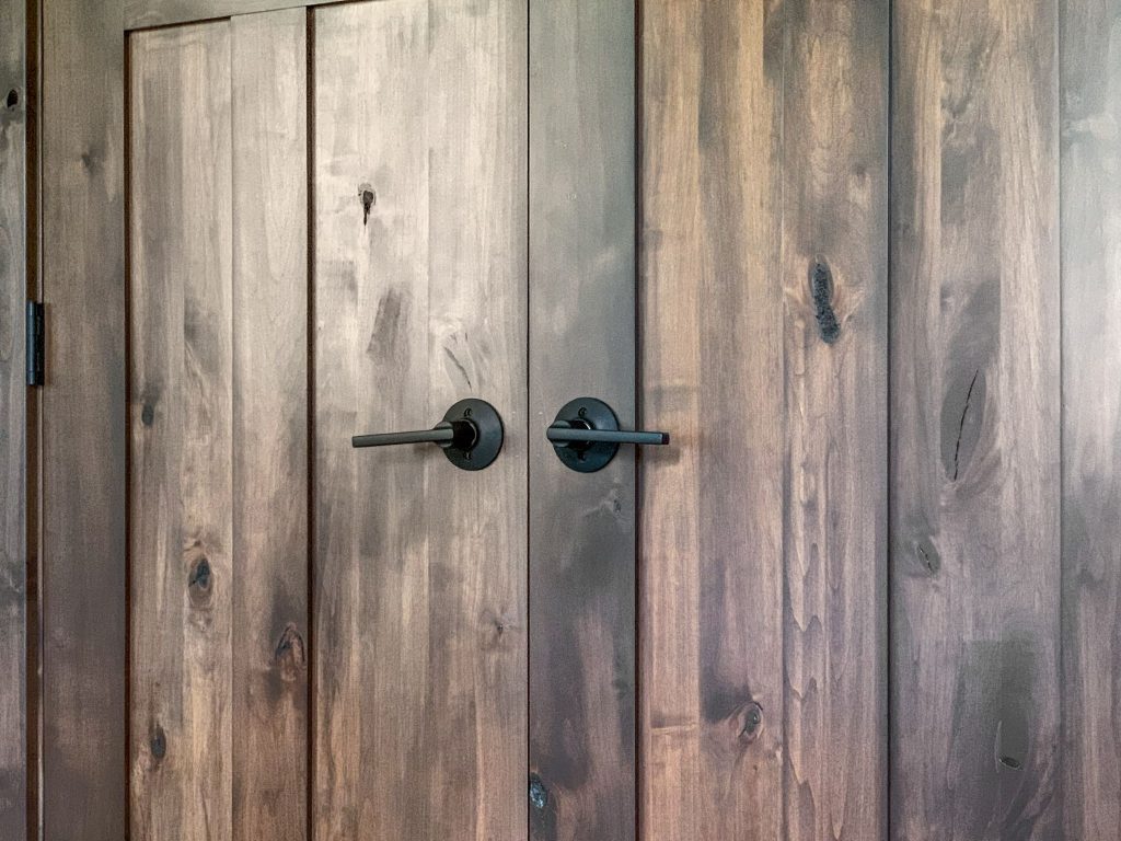 A close up of a wooden closet door.