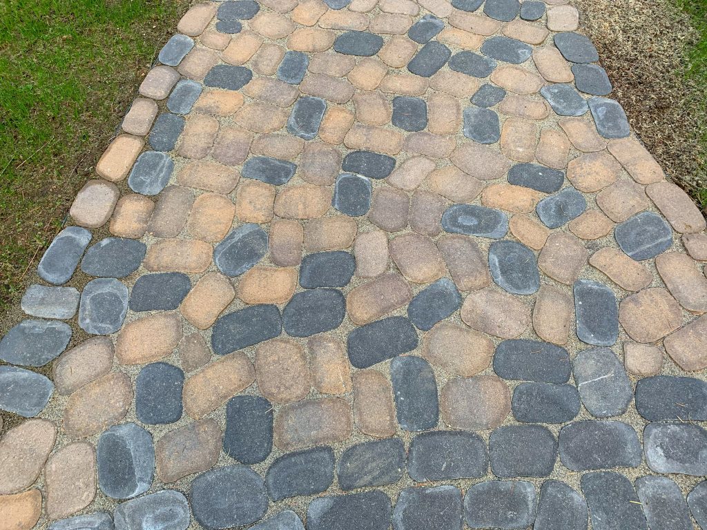 A walkway made of pavers and stones.