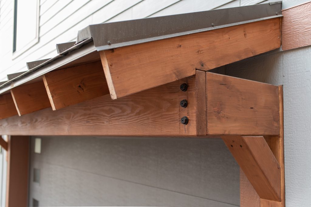 A wooden awning on the side of a house.