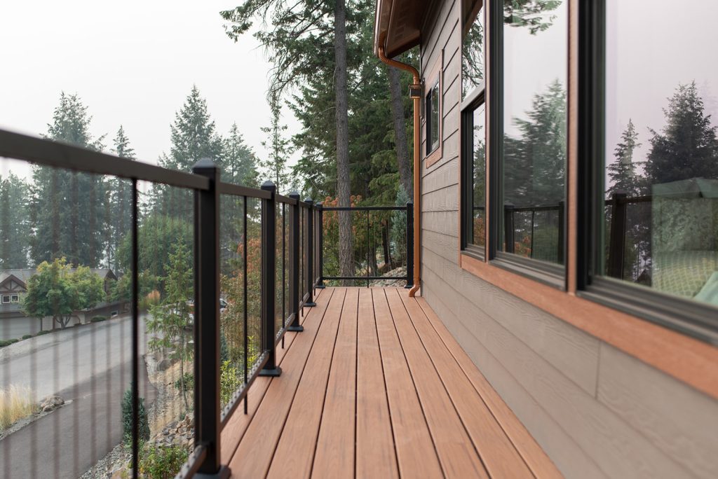 A deck with a railing and a window.