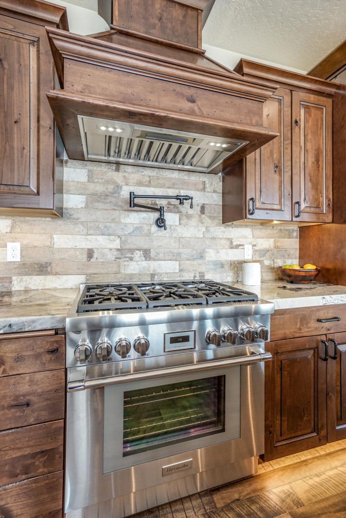 A kitchen with stainless steel appliances and wood cabinets.