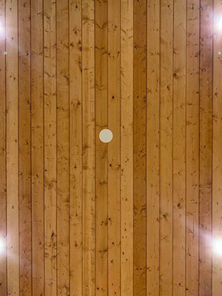 A wooden ceiling with a light shining on it.