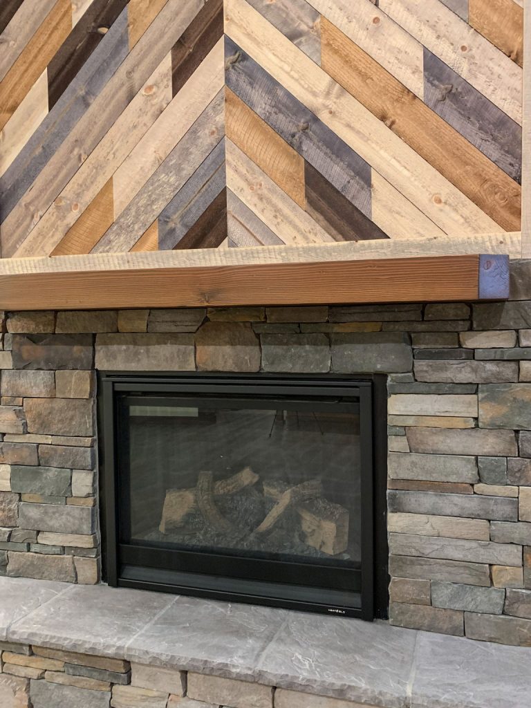 A fireplace with a wooden mantle made of wood.