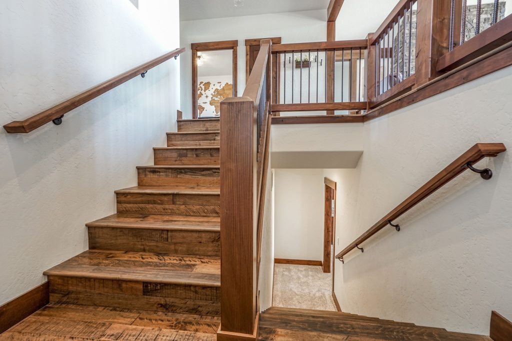 A staircase with wooden treads and railings in a home.