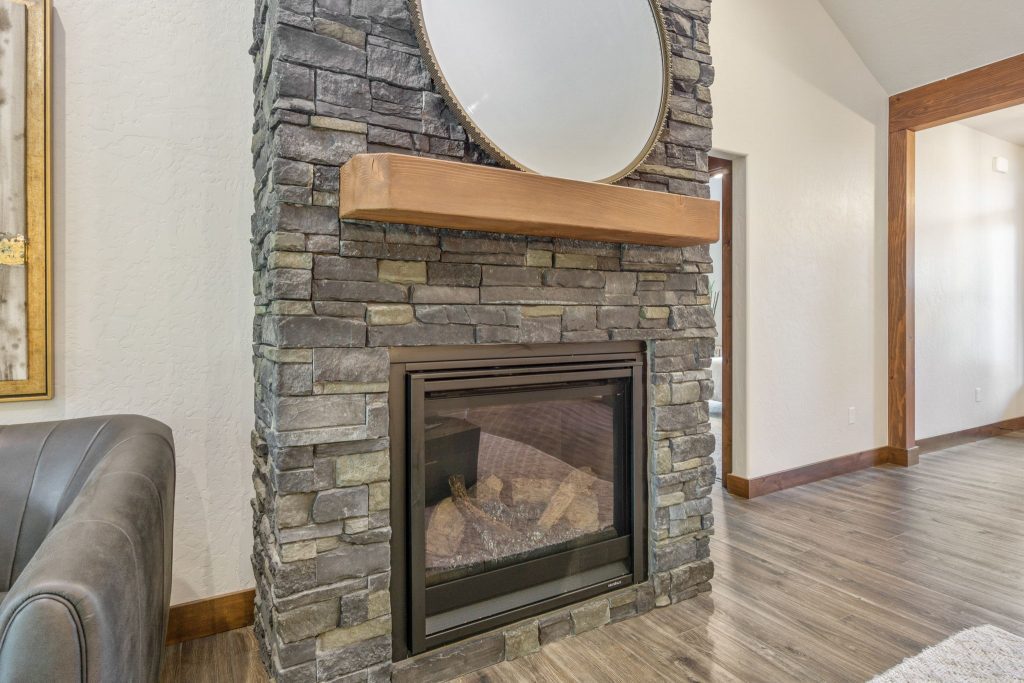 A stone fireplace in a living room.