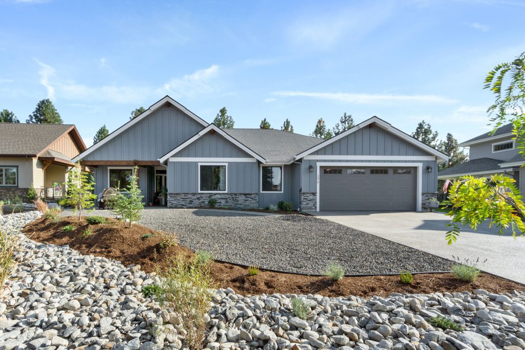 A home with a gravel driveway and landscaping.