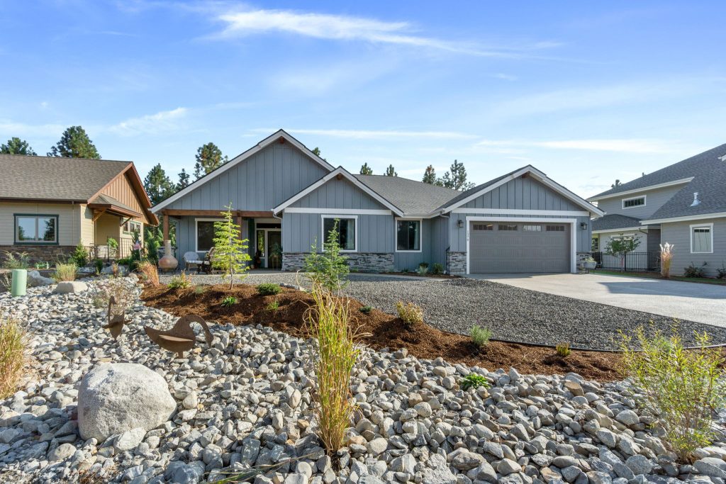 A home with gravel and rocks in front of it.