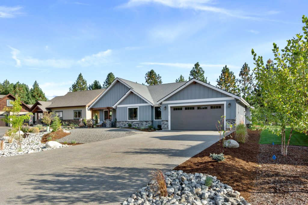 A home with a driveway and gravel driveway.