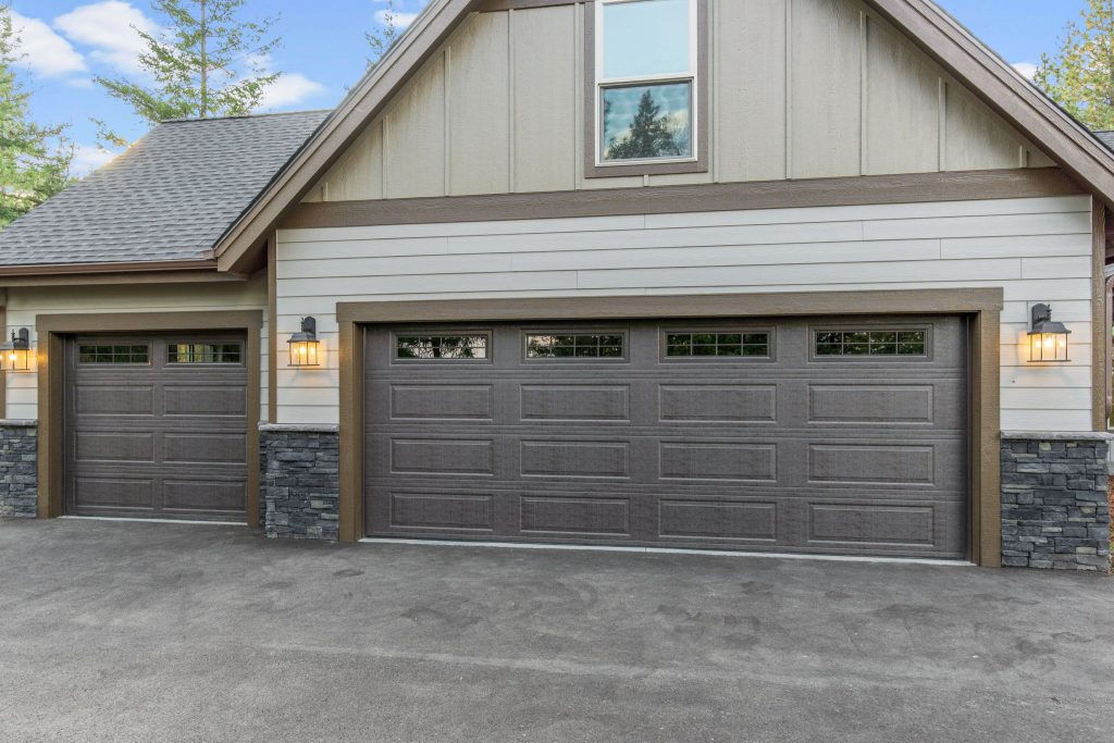 A house with a garage door and a driveway.