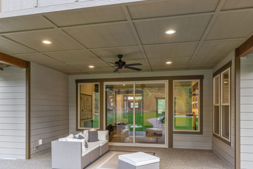 The front porch of a home with a sliding glass door.
