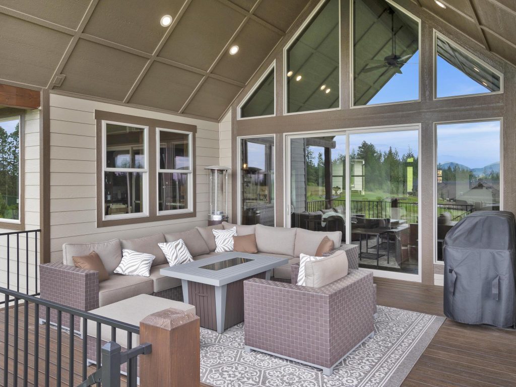 A large patio with furniture and a view of the mountains.