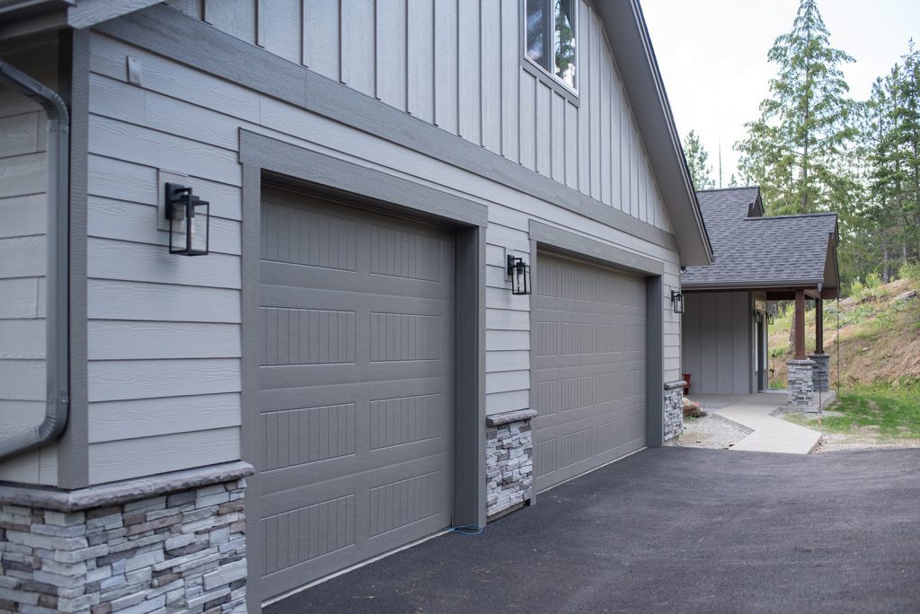 A house with two garage doors and a driveway.