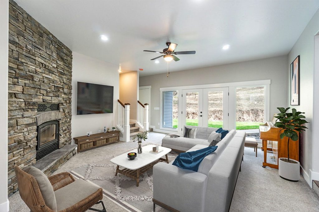 A living room with a fireplace and a stone wall.