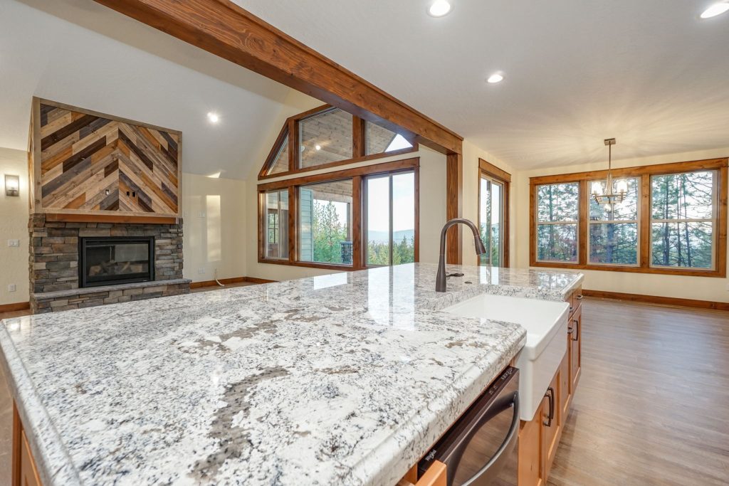 A kitchen with granite counter tops and a fireplace.
