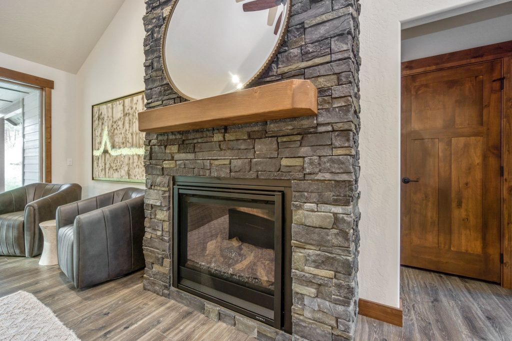 A stone fireplace in a living room.