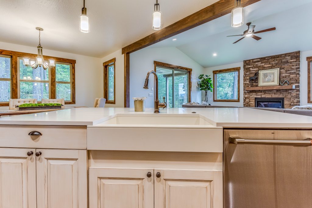 A kitchen with white cabinets and a sink.