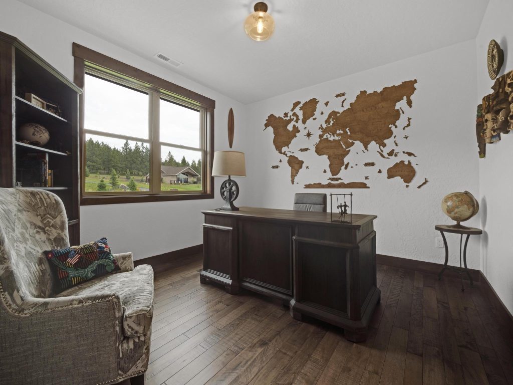 A home office with a world map on the wall.