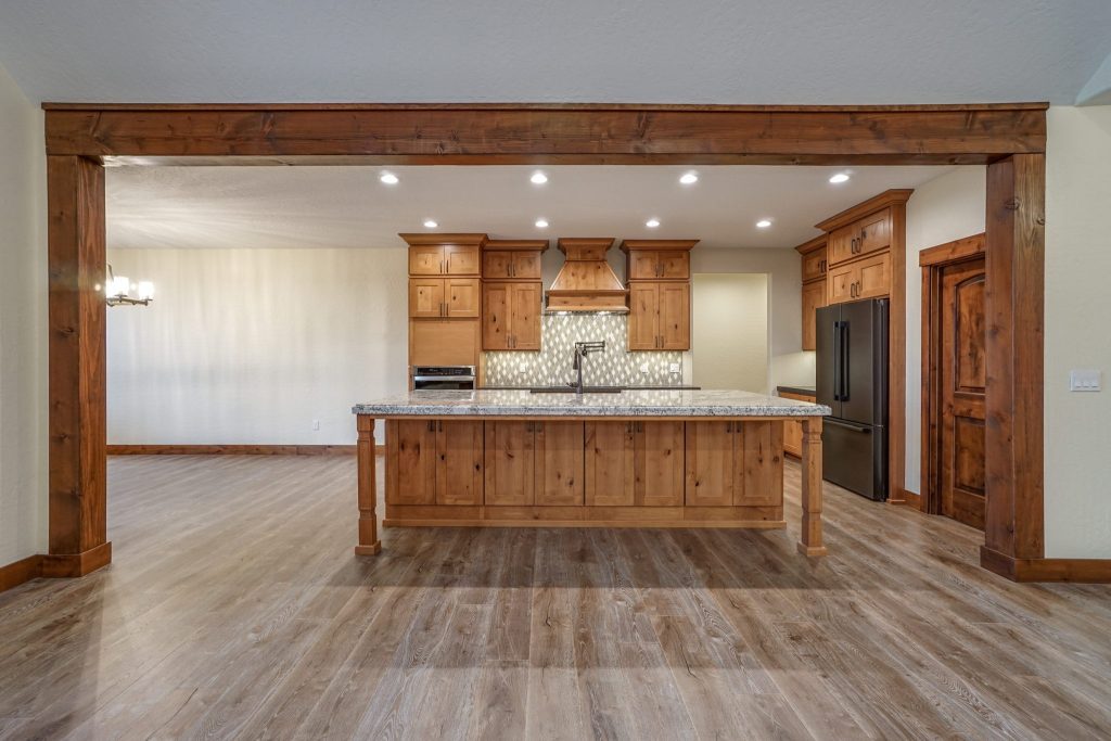 A kitchen with wood floors and a large island.