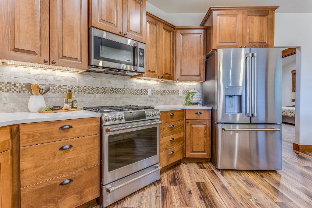 A kitchen with wood cabinets and stainless steel appliances.