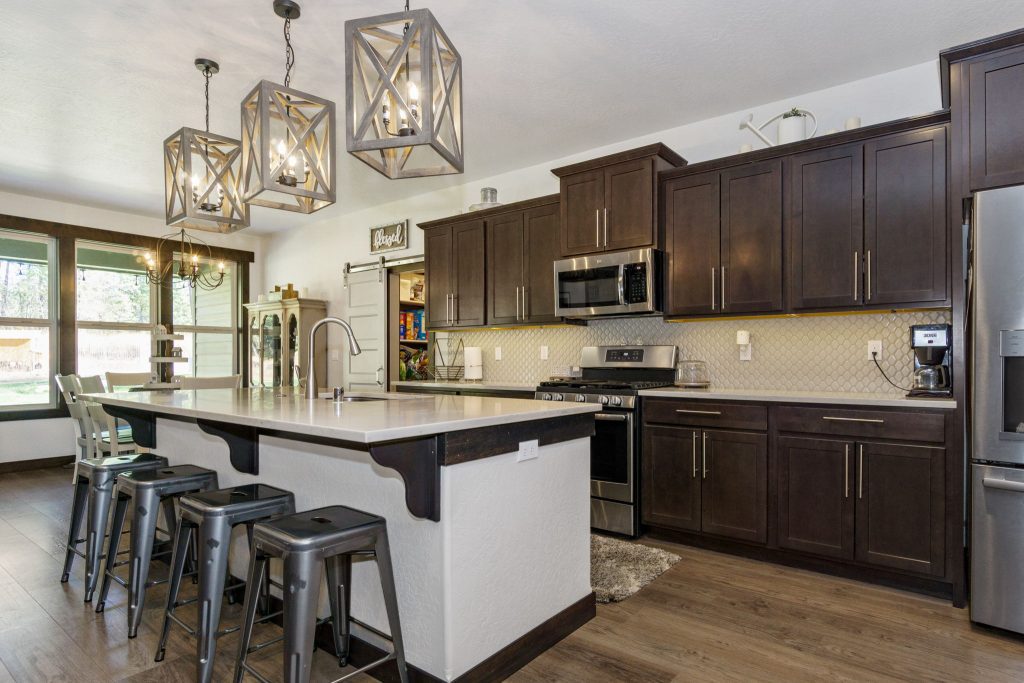 A kitchen with dark wood cabinets and stainless steel appliances.