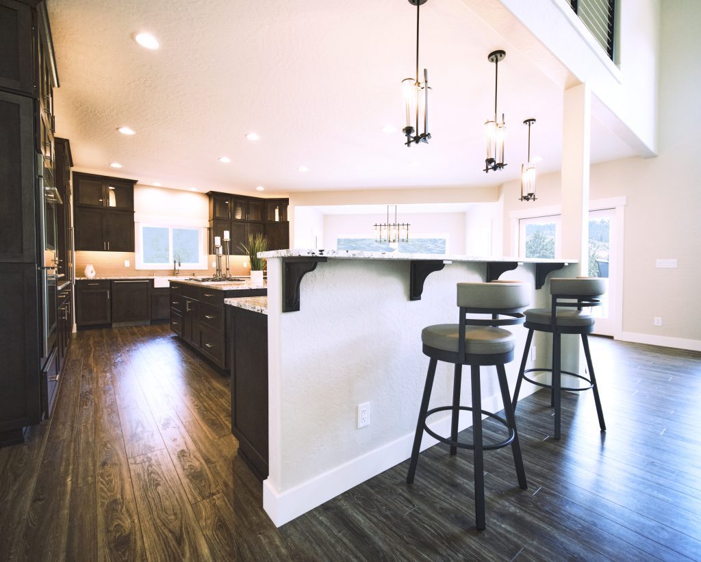 A kitchen with a large island and bar stools.