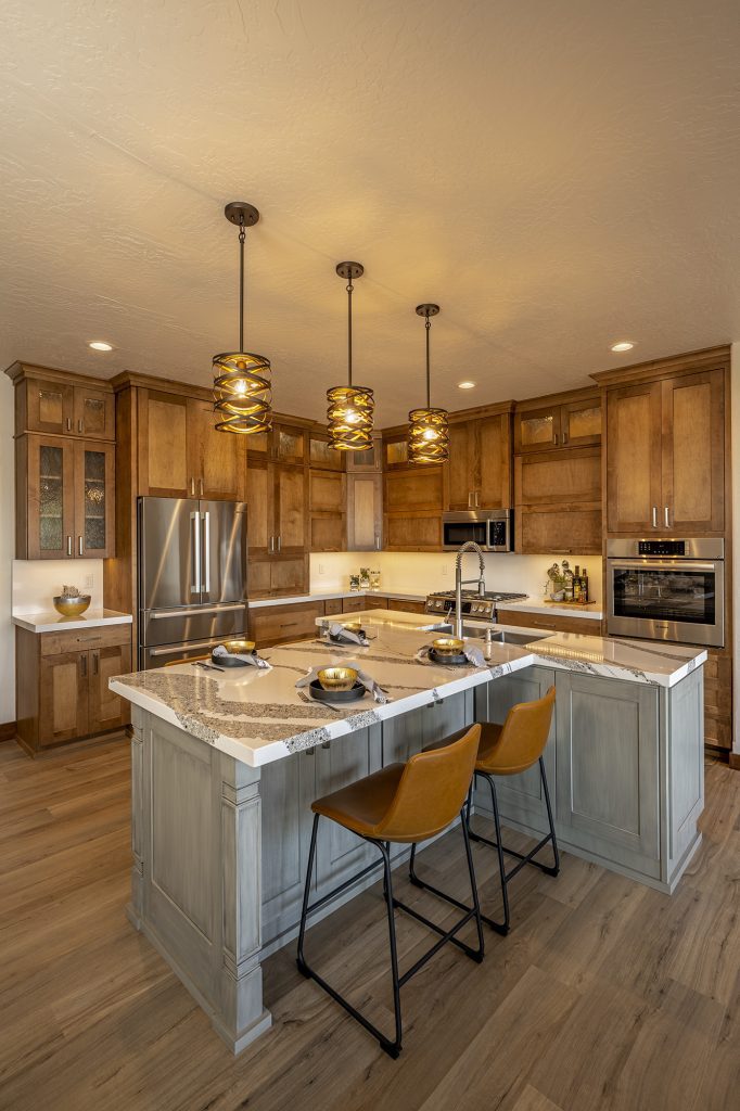 A kitchen with a center island and wooden cabinets.